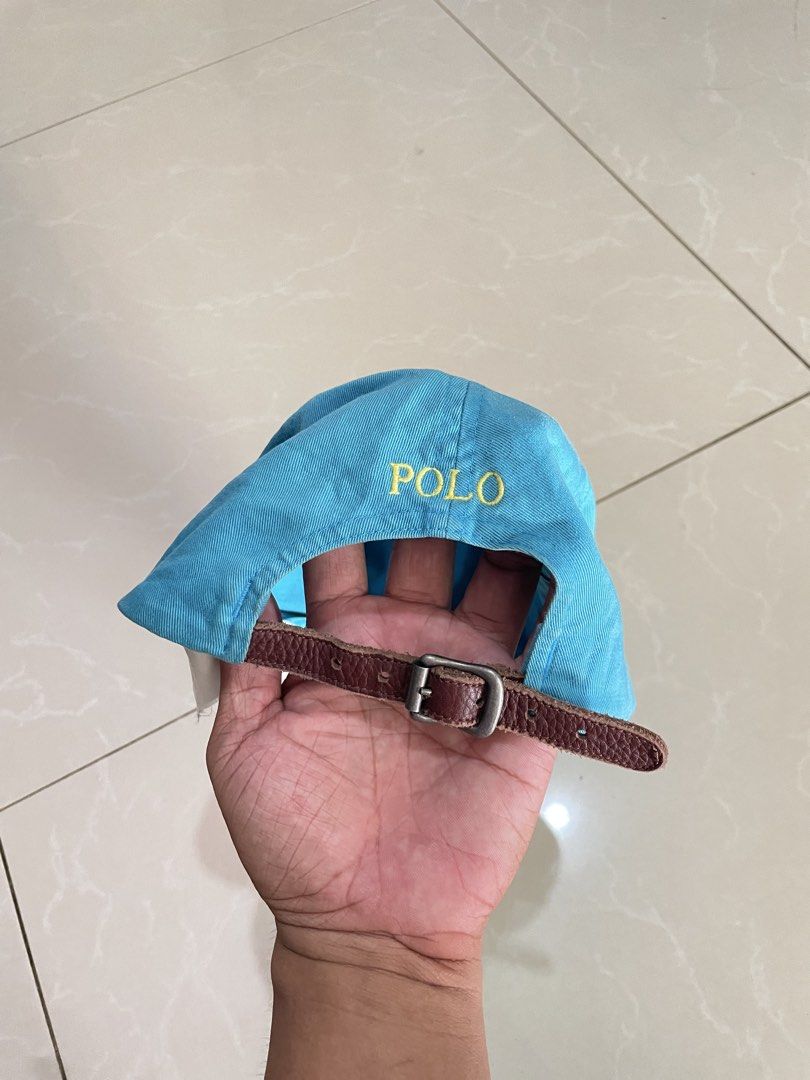 Polo Ralph Lauren Blue Cap with Leather Strap (Category: Caps & Hats) located in Iligan City. Submitted by farrisal (Listing ID 1468994829, Image 2). Description: - Authentic Polo Ralph Lauren cap in vibrant bright blue - Embroidered yellow pony logo on the front and POLO lettering on the back - Premium brown leather adjustable strap with a durable metal buckle - Made from 100% breathable cotton for all-day comfort - Classic design that easily pa