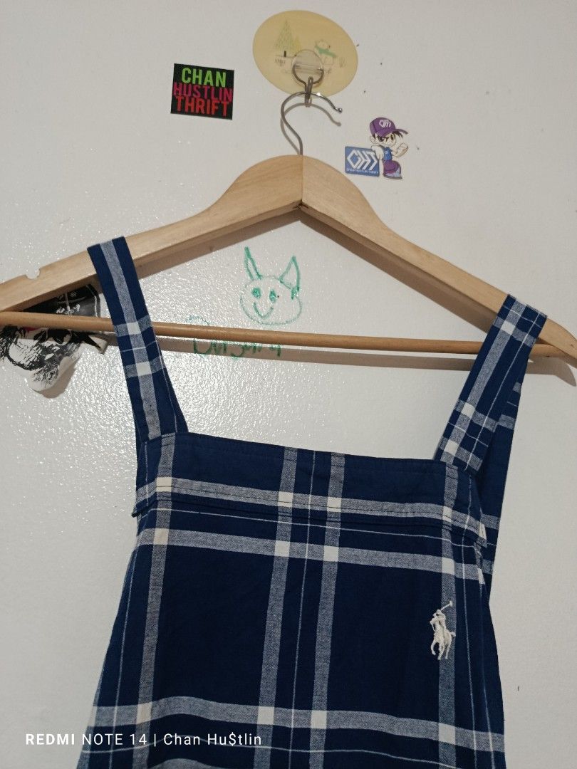 Polo Ralph Lauren Blue Plaid Apron (Category: Cleaning Tools & Supplies) located in Calamba. Submitted by chanmagpantay (Listing ID 1469085358, Image 2). Description: - Blue plaid apron - Features a square neckline, thick shoulder straps, and midi length - Authentic white embroidered Polo Ralph Lauren pony logo on the upper chest - Convenient side pockets and adjustable back tie closure - Easy to layer over t-shirts or long sleeve tops for any se