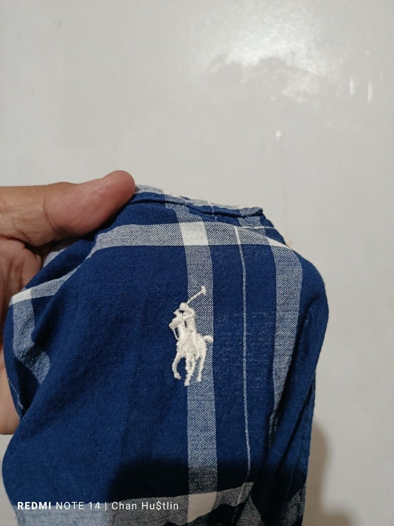 Polo Ralph Lauren Blue Plaid Apron (Category: Cleaning Tools & Supplies) located in Calamba. Submitted by chanmagpantay (Listing ID 1469085358, Image 3). Description: - Blue plaid apron - Features a square neckline, thick shoulder straps, and midi length - Authentic white embroidered Polo Ralph Lauren pony logo on the upper chest - Convenient side pockets and adjustable back tie closure - Easy to layer over t-shirts or long sleeve tops for any se