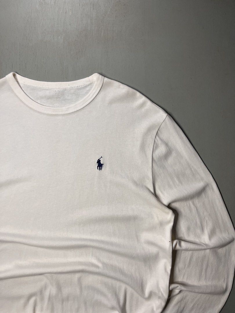 Polo Ralph Lauren White (Category: Tshirts & Polo Shirts ) located in Catbalogan. Submitted by yellfindss (Listing ID 1469131232, Image 2). Description: - Brand: Polo Ralph Lauren -22/27 - Color: Classic White with Navy Blue embroidered pony logo - Style: Long-sleeve tee with ribbed crewneck and cuffs - Material: Soft, premium cotton - Condition: Excellent / Clean look - Perfect for: Casual wear, layering, and everyday styling.