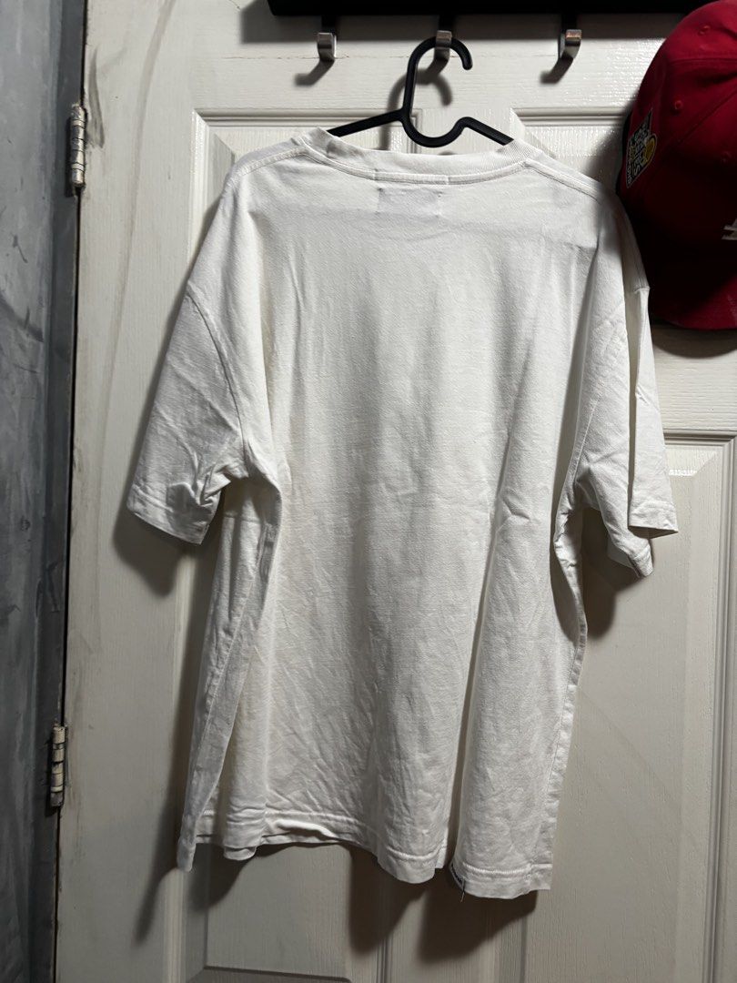 Poshbrain White Graphic T-Shirt (Category: Tshirts & Polo Shirts ) located in Quezon City. Submitted by .sachii_ (Listing ID 1469024675, Image 2). Description: - Brand: Poshbrain - Color: White with large front graphic - Material: Soft, comfortable cotton - Details: Classic crew neck, short sleeves, red interior collar label - Condition: Excellent/Clean, zero stains or holes.