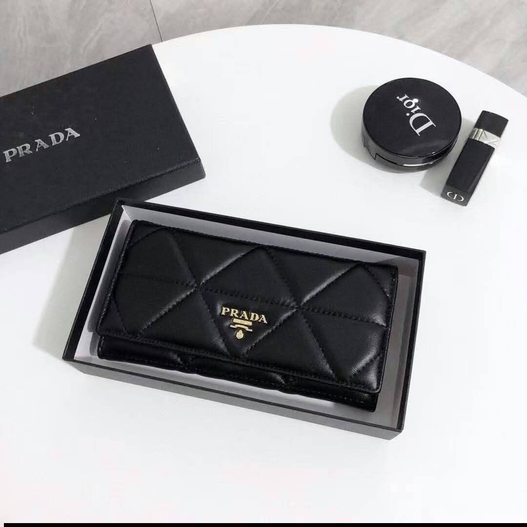 Prada Black Quilted Leather Wallet with Box (Category: Luxury Bags & Wallets) located in Manila. Submitted by iliasjen3082126 (Listing ID 1468997264, Image 1). Description: Prada black quilted leather wallet - Elegant gold-tone hardware with prominent front logo lettering - Structured rectangular shape featuring clean, precise stitching - Keeps your cards, cash, and essentials safe and secure - Comes with a matching black branded gift box (great 