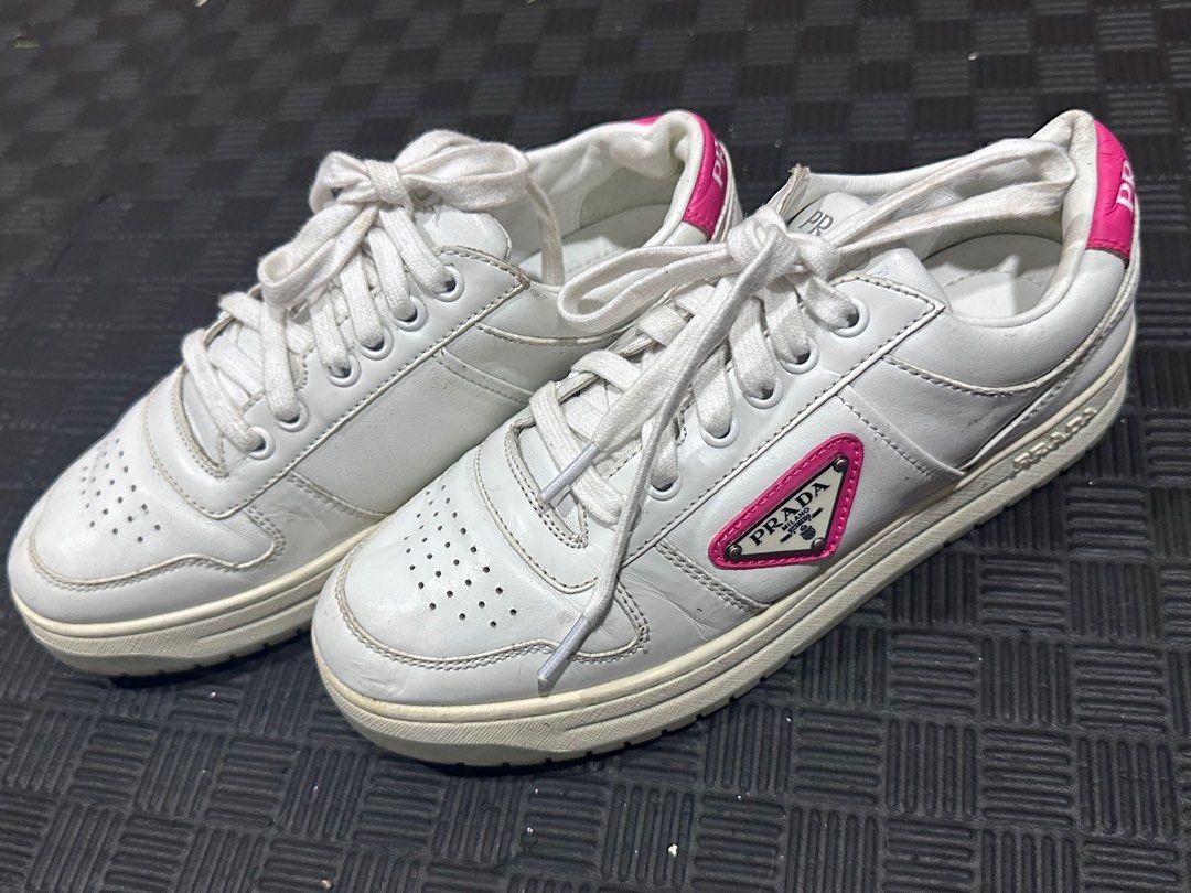 Prada Downtown Leather Sneakers (Category: Sneakers) located in Antipolo. Submitted by shopaho_nique (Listing ID 1469072083, Image 1). Description: AUTHENTIC Prada Downtown Leather Sneakers (White/Pink) Selling an authentic pair of women’s Prada Downtown low-tops in white with vibrant fuchsia pink accents and the iconic enameled triangle logo. • Model: Prada Downtown Low-Top (Style Code: 1E792M) • Size: EU 36 (Fits EU 36 - 36.5) • Material: 100% 