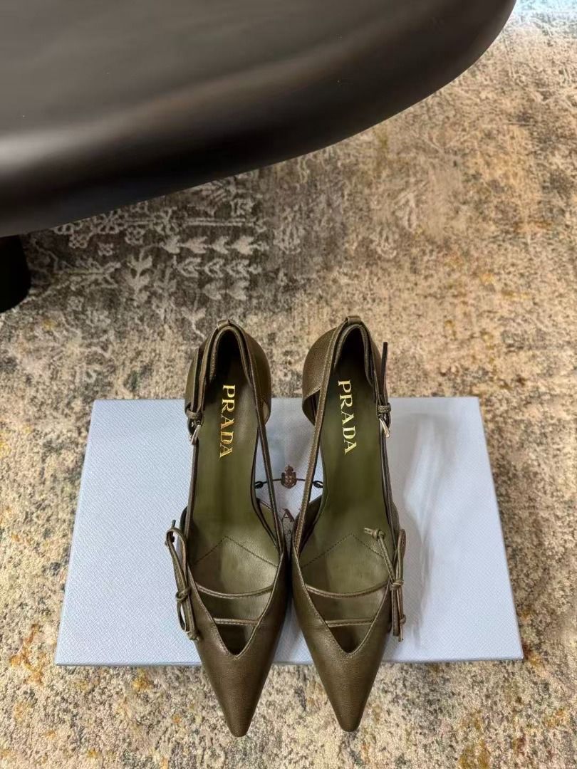 Prada Green Pointed Toe Heels With Bow Detail (Category: Heels) located in Manila. Submitted by kevingarci93240 (Listing ID 1469009322, Image 1). Description: - Authentic Prada pointed-toe heels in a rare olive green leather - Size: 38 (marked on sole) - Heel: Mid-height stiletto for comfortable elegance - Design: Front cutout with delicate thin straps and a small bow - Details: Gold Prada logo stamped on the inner sole - Fit: Slingback style wit