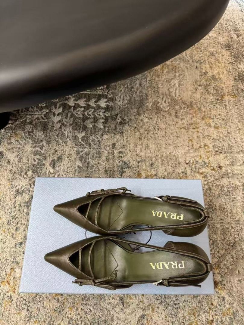 Prada Green Pointed Toe Heels With Bow Detail (Category: Heels) located in Manila. Submitted by kevingarci93240 (Listing ID 1469009322, Image 2). Description: - Authentic Prada pointed-toe heels in a rare olive green leather - Size: 38 (marked on sole) - Heel: Mid-height stiletto for comfortable elegance - Design: Front cutout with delicate thin straps and a small bow - Details: Gold Prada logo stamped on the inner sole - Fit: Slingback style wit