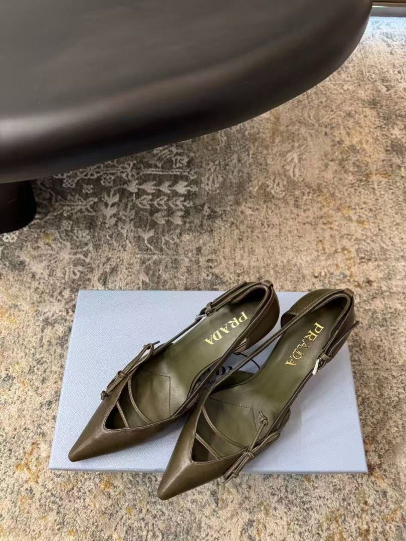 Prada Green Pointed Toe Heels With Bow Detail (Category: Heels) located in Manila. Submitted by kevingarci93240 (Listing ID 1469009322, Image 3). Description: - Authentic Prada pointed-toe heels in a rare olive green leather - Size: 38 (marked on sole) - Heel: Mid-height stiletto for comfortable elegance - Design: Front cutout with delicate thin straps and a small bow - Details: Gold Prada logo stamped on the inner sole - Fit: Slingback style wit