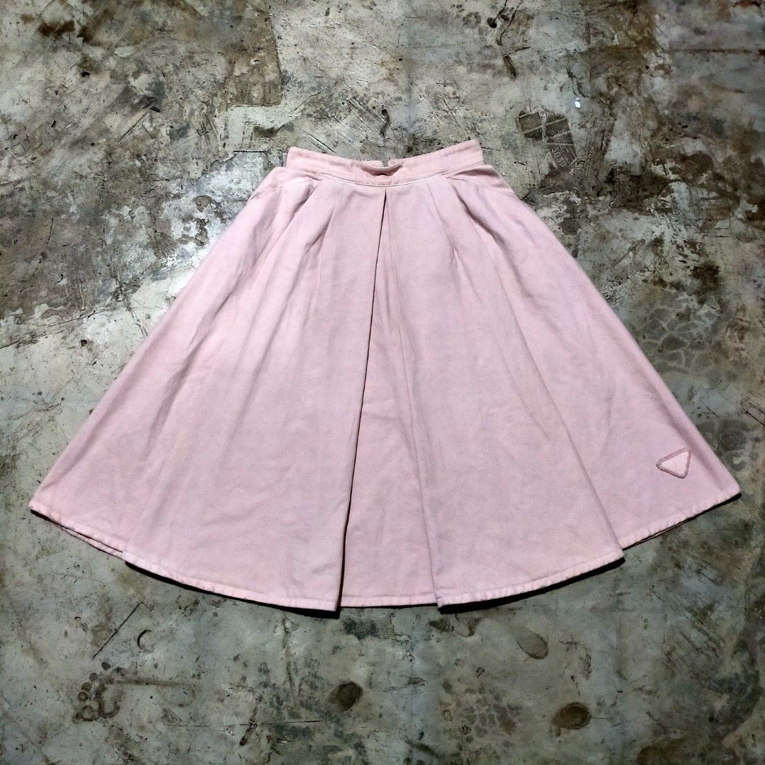 Prada Milano Pink Pleated Skirt (Category: Skirts) located in Zamboanga. Submitted by _oliverbmth (Listing ID 1468981942, Image 1). Description: - Brand: Prada Milano - Color: Pink - Material: 100% Cotton - Style: Mid-length flared cut with front pleats - Features: Convenient side pockets, zipper closure with branded hardware, and subtle triangular embroidered patch near the hem - Authenticity details: Blue brand label stitched inside near the wa