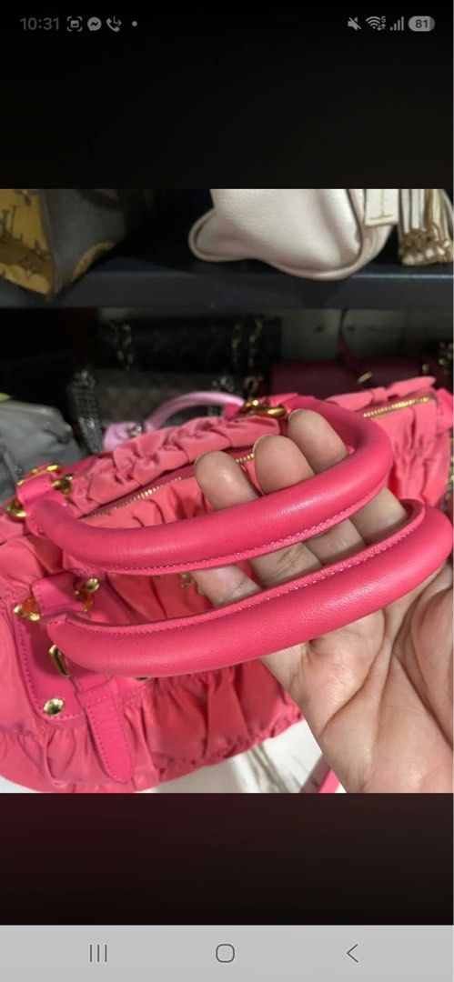 Prada Pink Nylon Ruched Satchel Handbag (Category: Luxury Bags & Wallets) located in Manila. Submitted by jeromskito66462 (Listing ID 1468991585, Image 2). Description: - Authentic bright pink Prada satchel bag in stylish gathered nylon fabric - Elegant gold-tone hardware and durable leather handles - Features buckled accent straps and the classic front metal logo plaque - Includes a convenient detachable shoulder strap for versatile wear - Clean