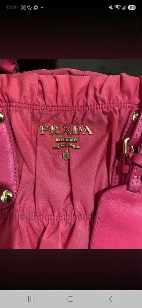 Prada Pink Nylon Ruched Satchel Handbag (Category: Luxury Bags & Wallets) located in Manila. Submitted by jeromskito66462 (Listing ID 1468991585, Image 3). Description: - Authentic bright pink Prada satchel bag in stylish gathered nylon fabric - Elegant gold-tone hardware and durable leather handles - Features buckled accent straps and the classic front metal logo plaque - Includes a convenient detachable shoulder strap for versatile wear - Clean