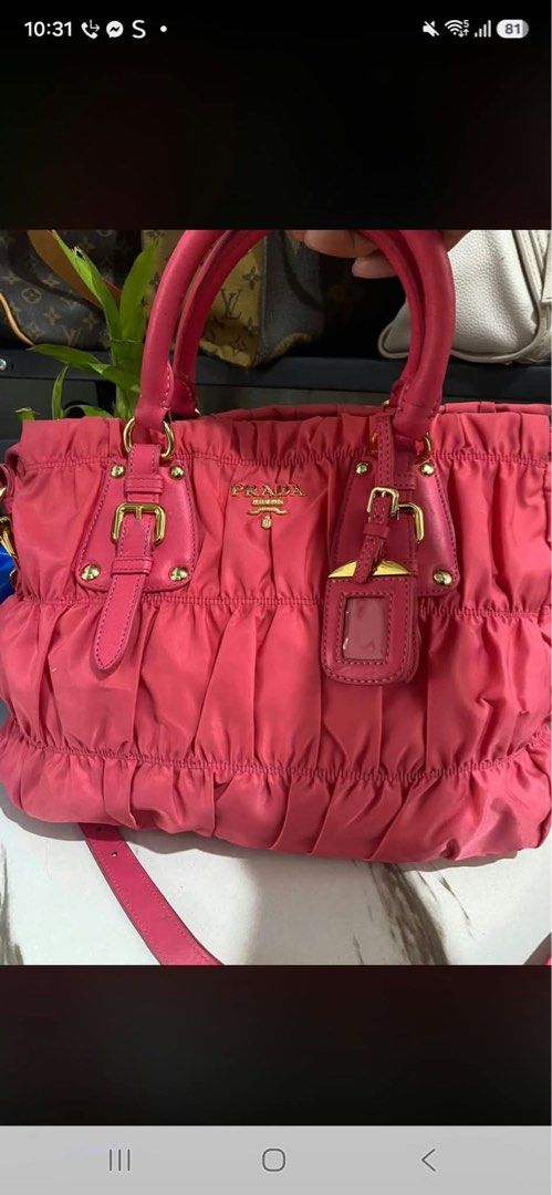 Prada Pink Nylon Ruched Satchel Handbag (Category: Luxury Bags & Wallets) located in Manila. Submitted by jeromskito66462 (Listing ID 1468991585, Image 1). Description: - Authentic bright pink Prada satchel bag in stylish gathered nylon fabric - Elegant gold-tone hardware and durable leather handles - Features buckled accent straps and the classic front metal logo plaque - Includes a convenient detachable shoulder strap for versatile wear - Clean