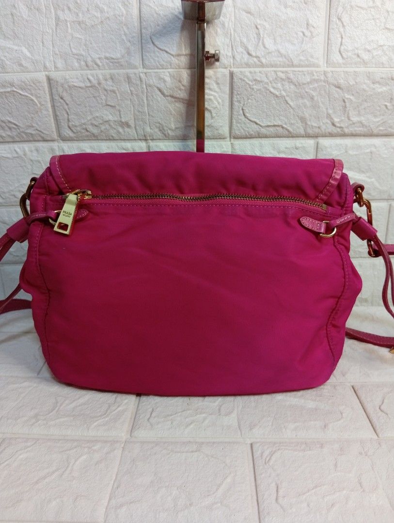 Prada Pink Tessuto Nylon Messenger Bag (Category: Luxury Bags & Wallets) located in Las Pinas. Submitted by etoksi1234 (Listing ID 1469119291, Image 2). Description: Pre-loved Prada bright pink nylon crossbody bag featuring gold hardware, a front flap with dual buckles, and adjustable strap. Made in Italy..