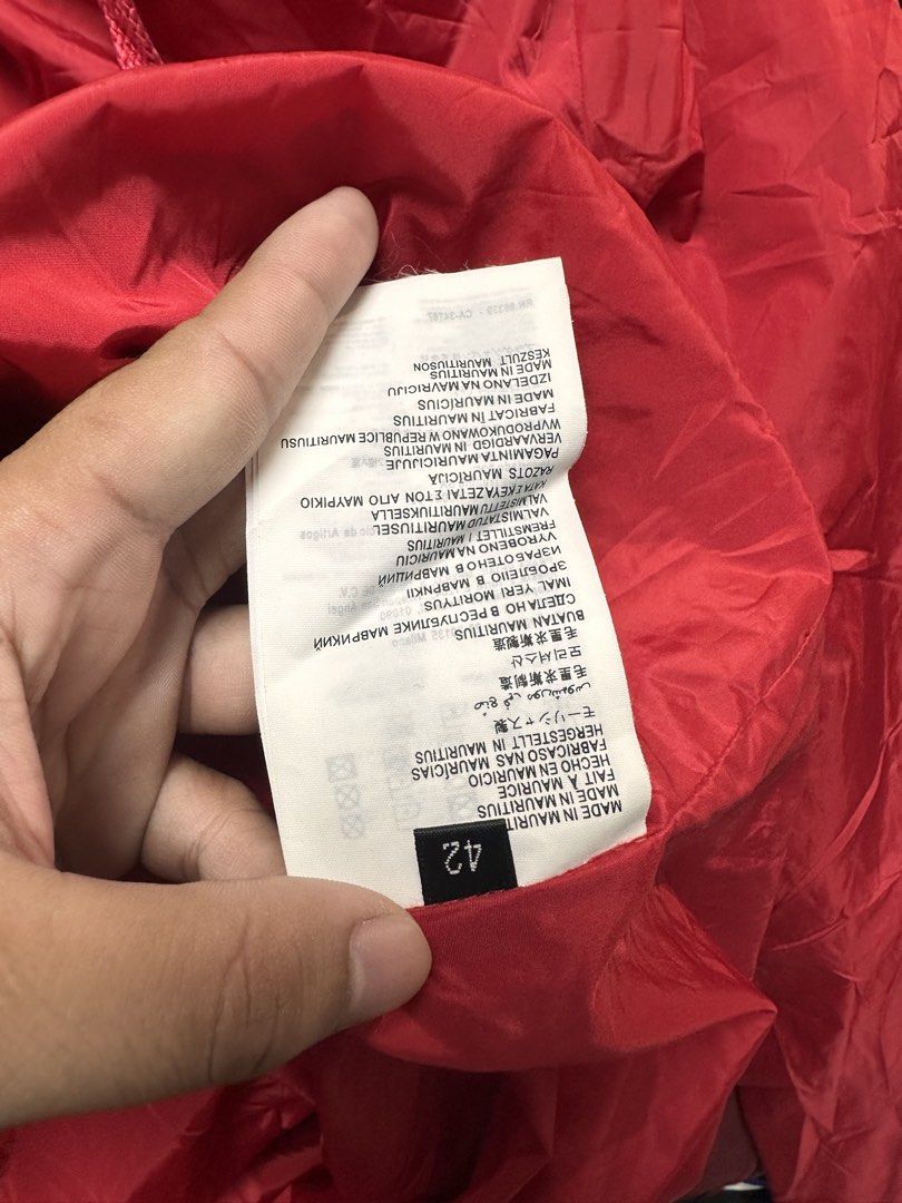 Prada Red Nylon Zip Jacket Size 42 (Category: Coats, Jackets and Outerwear) located in Manila. Submitted by rashidgaddi (Listing ID 1468933773, Image 2). Description: - Brand: Prada - Item: Nylon Jacket - Color: Bright Red with light blue inner collar tag - Size: 42 (Tag attached) - Origin: Made in Mauritius - Material: Viscose, polyester, and other fabric blends - Features: Full front zipper with branded metal pull, clean red inner lining - Cond