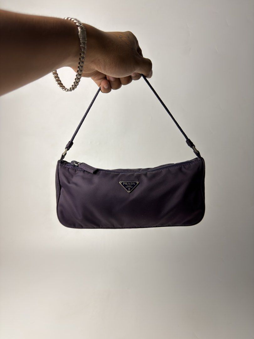 Prada Tessuto Nylon Mini Shoulder Bag (Category: Luxury Bags & Wallets) located in Manila. Submitted by streetsavvy (Listing ID 1469024716, Image 2). Description: Prada Tessuto Nylon Mini Shoulder Bag Width: 10” Height: 4.5” Depth: 2.5” Strap Drop: 5” Measured in Inches features a classic curved mini hobo profile with clean, geometric lines that taper subtly at the sides. Its flexible Tessuto nylon body allows the bag to hold its shape naturally 