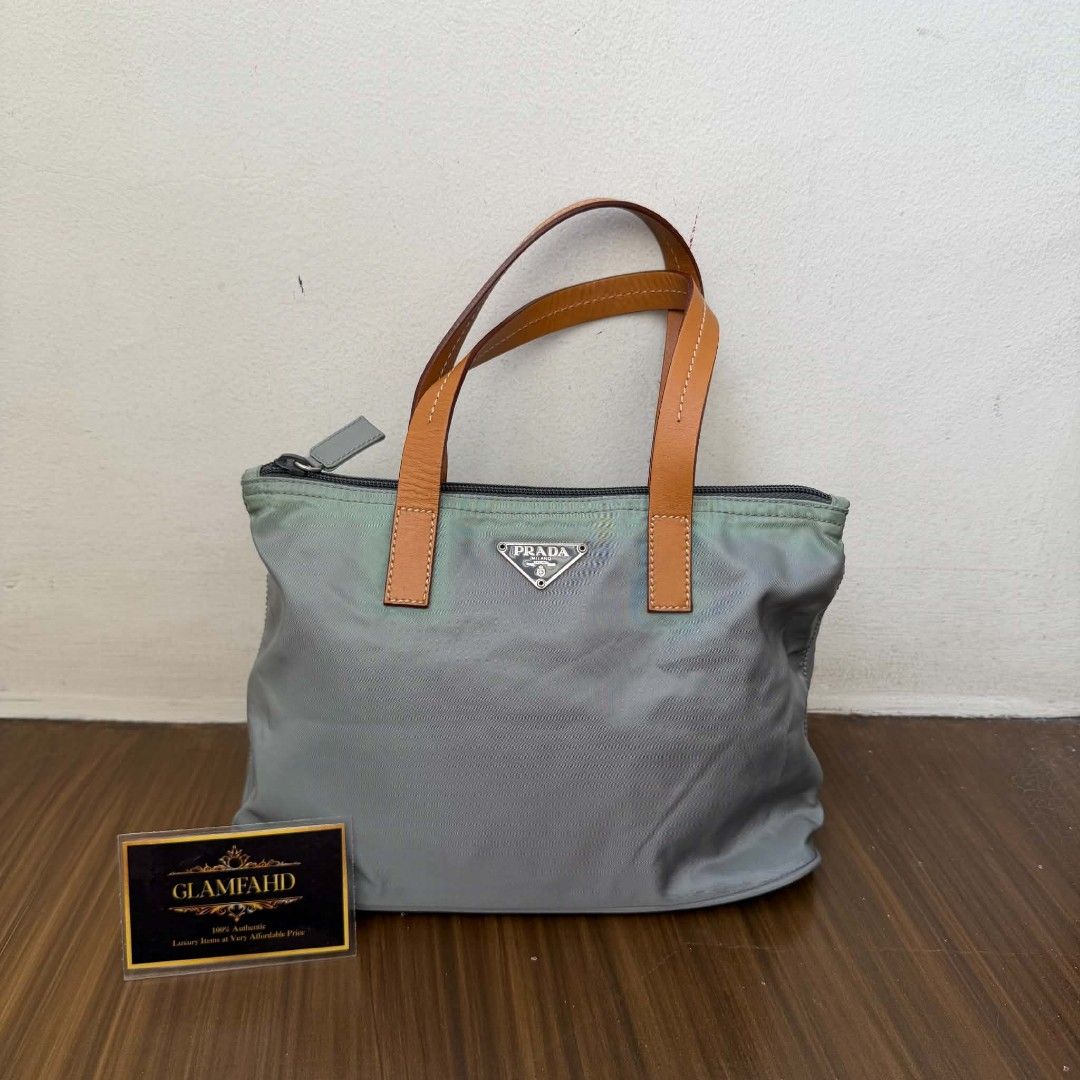 PRE OWNED AUTHENTIC PRADA NYLON BAG (Category: Luxury Bags & Wallets) located in Paranaque City. Submitted by Glamfahd (Listing ID 1469076370, Image 1). Description: Pre Owned Authentic PRADA Bag Inclusion/s: None Condition Well Used condition Marks on exterior Marks on interior Tolerable fade of color on few area visible in close inspection Bag is really a great buy! Please manage your expectations as you are buying an authentic second hand item