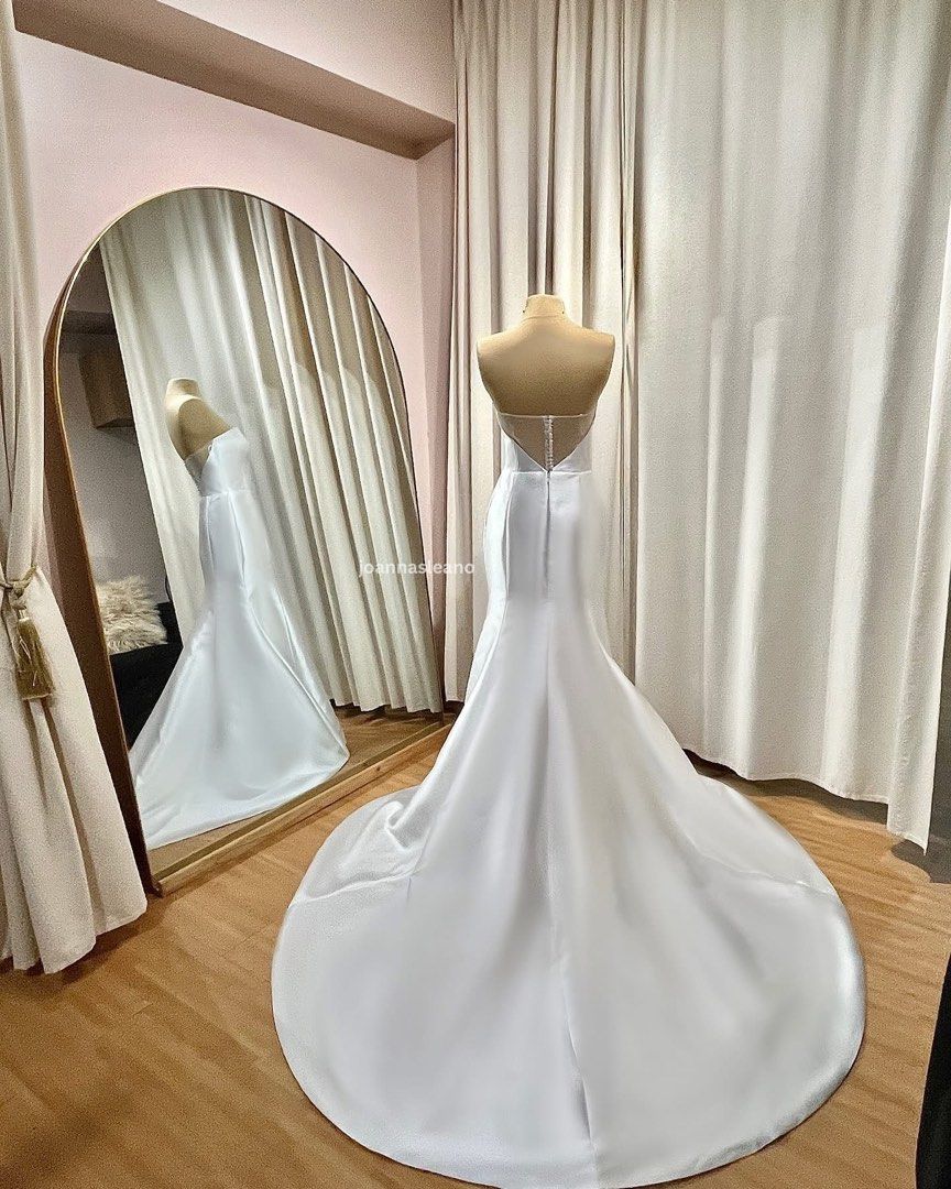 PRELOVED NIKEA ATELIER WEDDING GOWN (Category: Evening dresses & gowns) located in Quezon City. Submitted by ajsl23 (Listing ID 1469057308, Image 2). Description: Nikea Atelier • Off-shoulder mermaid silhouette • Fits XS-S • Excellent condition • Professionally dry cleaned • Detachable off-shoulder mesh sleeves • Veil included • Original gown box included Quezon City.