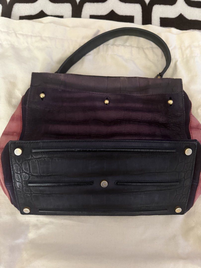Preloved YSL MUSE2 (Category: Luxury Bags & Wallets) located in Cainta. Submitted by missfunkyshoppe (Listing ID 1468960463, Image 3). Description: - Two-tone purple and dusty rose leather shoulder bag - Stylish embossed crocodile pattern throughout - Secure gold-tone hardware closure on the front flap - Structured bottom panel with protective metal feet and support bars - Single top handle attached with durable rings - Condition: Good condition.