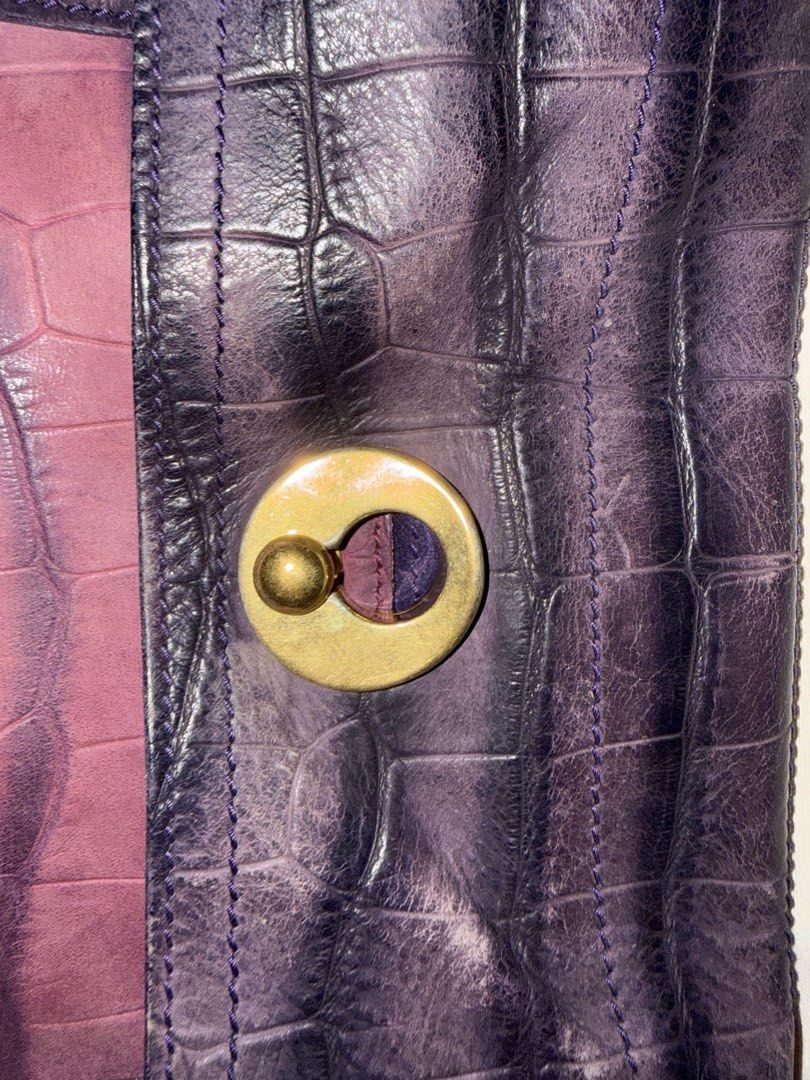 Preloved YSL MUSE2 (Category: Luxury Bags & Wallets) located in Cainta. Submitted by missfunkyshoppe (Listing ID 1468960463, Image 2). Description: - Two-tone purple and dusty rose leather shoulder bag - Stylish embossed crocodile pattern throughout - Secure gold-tone hardware closure on the front flap - Structured bottom panel with protective metal feet and support bars - Single top handle attached with durable rings - Condition: Good condition.