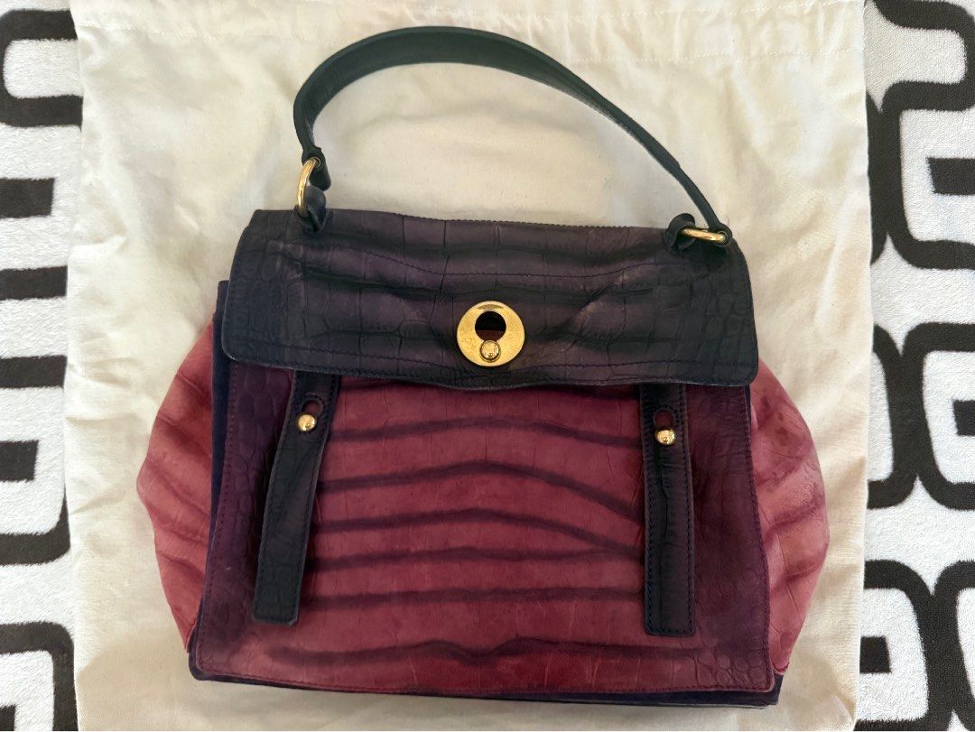 Preloved YSL MUSE2 (Category: Luxury Bags & Wallets) located in Cainta. Submitted by missfunkyshoppe (Listing ID 1468960463, Image 1). Description: - Two-tone purple and dusty rose leather shoulder bag - Stylish embossed crocodile pattern throughout - Secure gold-tone hardware closure on the front flap - Structured bottom panel with protective metal feet and support bars - Single top handle attached with durable rings - Condition: Good condition.