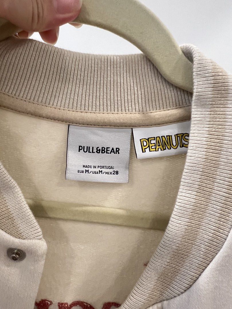 Pull & Bear x Peanuts Varsity Jacket Cream Size M (Category: Coats, Jackets and Outerwear) located in Quezon City. Submitted by iam.yanuhh (Listing ID 1469108146, Image 3). Description: - used twice only - Authentic Pull & Bear x Peanuts collaboration varsity jacket - Color: Cream body with beige sleeves - Size: EUR M, USA M, MEX 28 - Material: Warm cotton blend, made in Portugal - Design details: Snap-button closure, striped ribbed cuffs and hem
