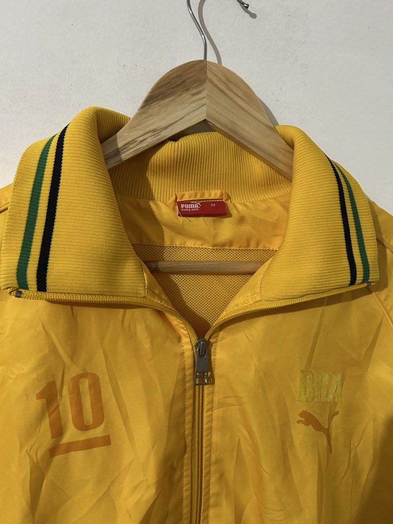 Puma Brazil Track Jacket Yellow Size M (Category: Coats, Jackets and Outerwear) located in Manila. Submitted by livedog-d301 (Listing ID 1468936332, Image 3). Description: - Brand: Puma - Theme: Brazil Football / Retro - Color: Bright yellow with green and black accents - Size: Medium (M) - Design: Iconic number 10 printed on front and back, PUMA leaping cat logo, and Brasil branding on chest - Details: Full zip closure, tall ribbed collar, strip