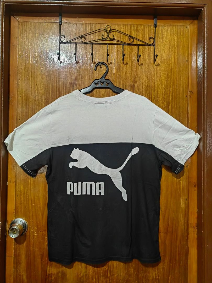 Puma White T-Shirt XL (Category: Shirts) located in Caloocan City. Submitted by carolanglu40603 (Listing ID 1469005825, Image 2). Description: - Brand: Puma - Size: XL - Color: White with green box logo on inner collar - Style: Classic crew neck, short sleeves - Condition: Soft and broken-in fabric, with some yellowish discoloration around the neckline from age and previous wear.