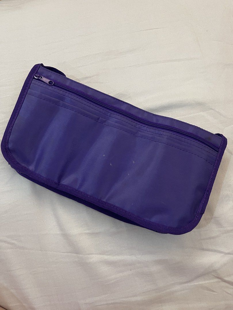 Purple Tote Bag Organizer Insert (Category: Tote Bags) located in Quezon City. Submitted by bravehorse_f1f6d5 (Listing ID 1469118887, Image 2). Description: - Color: Purple - Material: Durable nylon - Features: Multiple inside and outside pockets, two front flap pockets, and one zipped compartment - Benefits: Keeps your tote tidy and helps bags maintain their structured shape - Convenience: Makes switching purses quick and hassle-free.