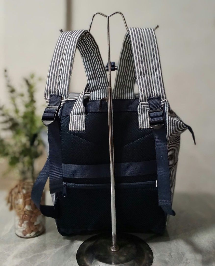 Qminica Navy and White Striped Backpack (Category: Backpacks) located in Manila. Submitted by cosmiccloud-9236 (Listing ID 1468964614, Image 2). Description: Navy and white vertical striped canvas backpack with the Qminica brand embroidered on the front. Double top handles and a front zipper pocket. Back straps are padded with black mesh material, adjustable with plastic buckles. Includes an extra security zip pocket on the back panel..
