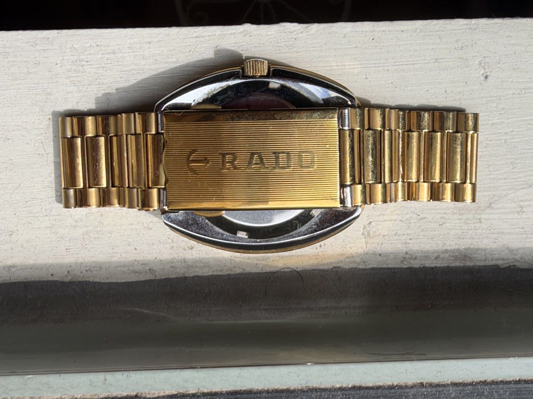 Rado Diastar Gold Watch with Gemstone Dial (Category: Women's Watches) located in Marikina City. Submitted by _julianpaolo (Listing ID 1468937653, Image 2). Description: - Authentic Vintage Rado Diastar gold-tone watch - Oval-shaped case with a striking vertical striped dial - Sparkling stone markers and eye-catching red accent gems - Convenient day and date display at the top - Matching gold link bracelet with original signed Rado clasp - Automa