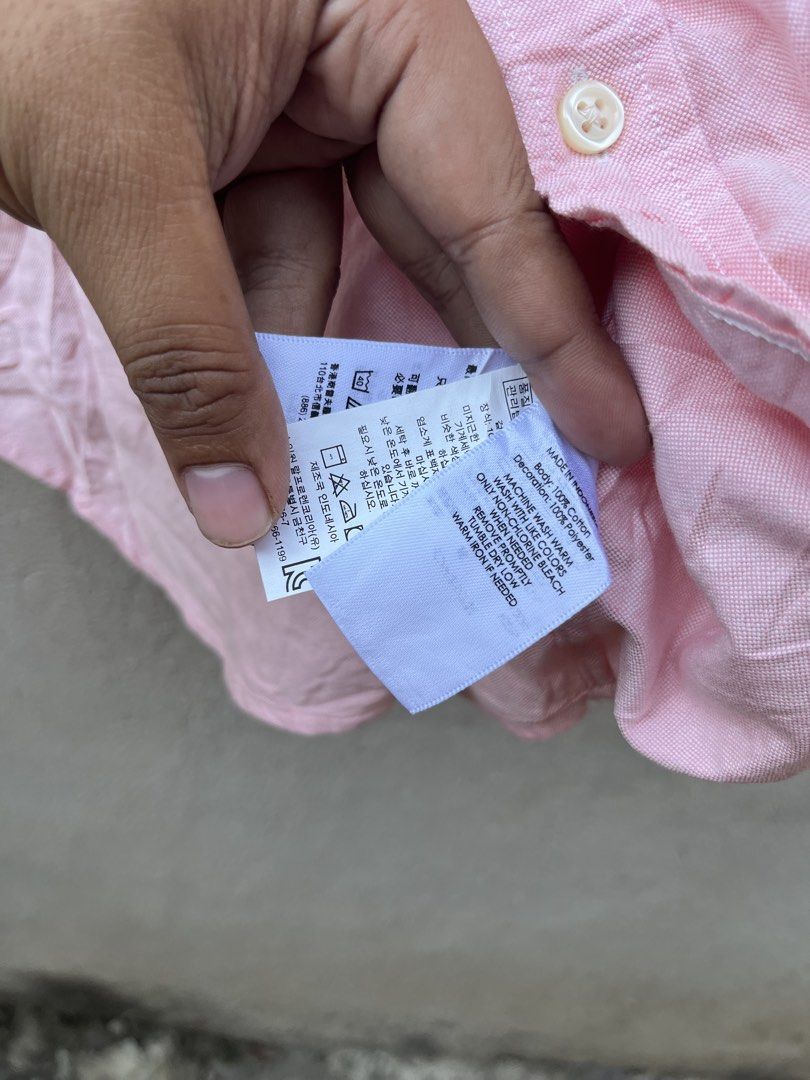 Ralph Lauren Pink Long Sleeve Button-Down Shirt (Category: Longsleeves) located in Claveria. Submitted by jhonbernar74435 (Listing ID 1469088140, Image 3). Description: - Brand: Ralph Lauren - Color: Pink - Style: Long sleeve button-down shirt with button-down collar - Material: 100% Oxford cotton - Size: 18 (165/84) - Details: Iconic embroidered pony logo on the chest, made in Indonesia - Condition: Brand new with original store tags attached.