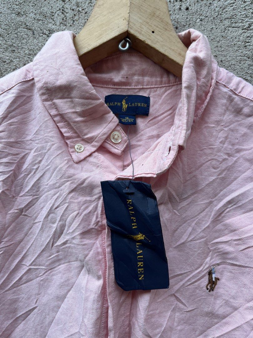 Ralph Lauren Pink Long Sleeve Button-Down Shirt (Category: Longsleeves) located in Claveria. Submitted by jhonbernar74435 (Listing ID 1469088140, Image 2). Description: - Brand: Ralph Lauren - Color: Pink - Style: Long sleeve button-down shirt with button-down collar - Material: 100% Oxford cotton - Size: 18 (165/84) - Details: Iconic embroidered pony logo on the chest, made in Indonesia - Condition: Brand new with original store tags attached.