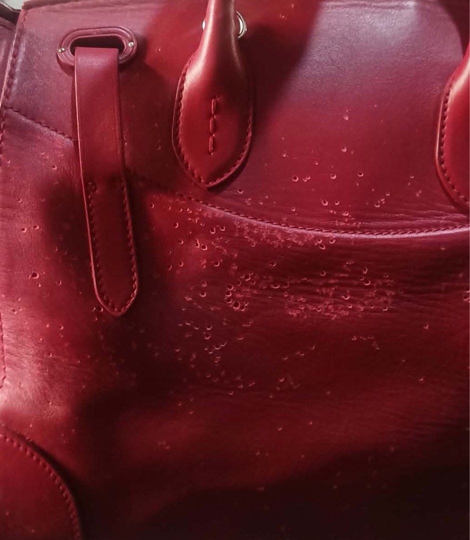 RALPH LAUREN TICKY BAG (PROJECT) (Category: Luxury Bags & Wallets) located in Masbate. Submitted by thon0806 (Listing ID 1469027479, Image 2). Description: - Color: Rich red - Material: Leather - Features: Dual top handles, silver hardware, front clasp closure, decorative strap accents, and a roomy interior - Condition: Noticeable flaking and surface peeling on the front exterior (shown in close-up); clean hardware and sturdy handles otherwise - 