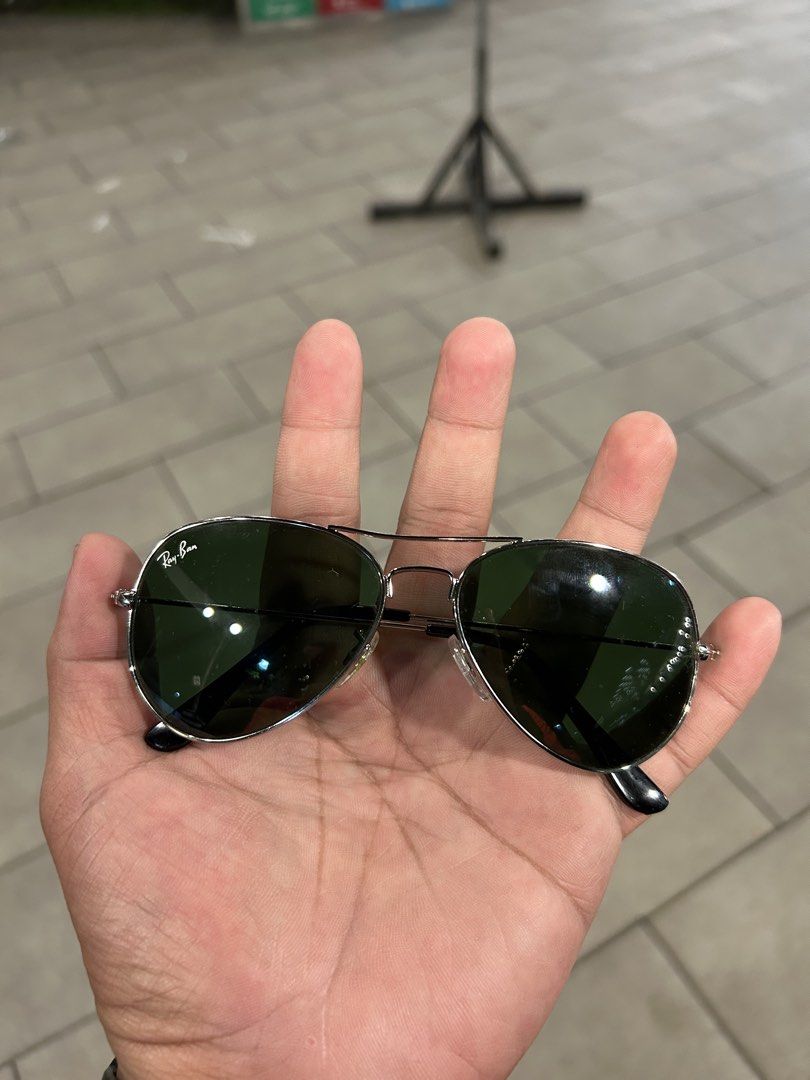 Ray-Ban Aviator Classic Silver Sunglasses (Category: Sunglasses & Eyewear) located in Angeles City. Submitted by cassey_phoenix (Listing ID 1468956388, Image 1). Description: - Authentic Ray-Ban Aviator sunglasses - Silver metal frame with classic green lenses - Iconic white Ray-Ban logo on the right lens - Double bridge design with adjustable nose pads - Lightweight, comfortable, and versatile for everyday use With legit rayban case.