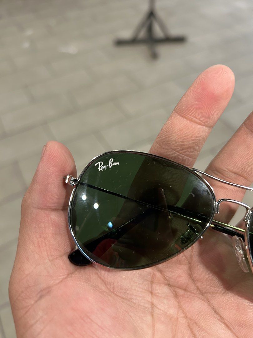 Ray-Ban Aviator Classic Silver Sunglasses (Category: Sunglasses & Eyewear) located in Angeles City. Submitted by cassey_phoenix (Listing ID 1468956388, Image 2). Description: - Authentic Ray-Ban Aviator sunglasses - Silver metal frame with classic green lenses - Iconic white Ray-Ban logo on the right lens - Double bridge design with adjustable nose pads - Lightweight, comfortable, and versatile for everyday use With legit rayban case.