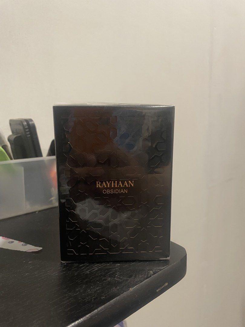 Rayhaan Obsidian Eau de Parfum for Men (Category: Fragrance & Deodorants) located in Quezon City. Submitted by brave_dowayne (Listing ID 1469128056, Image 3). Description: - Item: Rayhaan Obsidian Eau de Parfum for Men - Condition: Brand new in box, sealed with original plastic wrap (Never opened or sprayed) - Scent Profile: Rich oriental fragrance with dominant woody, iris, powdery, violet, leather, and earthy accords - Additional Notes: Subtle 