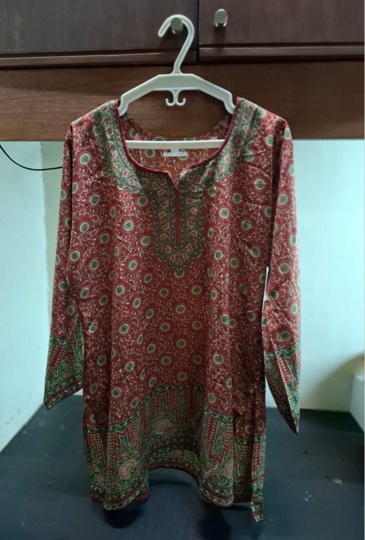 Red Indian Tunic Kurti Size XL (Category: Blouses) located in Muntinlupa City. Submitted by everythingmustgo_8475da (Listing ID 1469009628, Image 1). Description: - Size: XL - Color/Pattern: Red with green and beige patterns - Design: Long sleeves, round split neckline, detailed borders at hem and cuffs - Material: Lightweight fabric - Origin: Made in India - Condition/Style: Great casual everyday wear option.