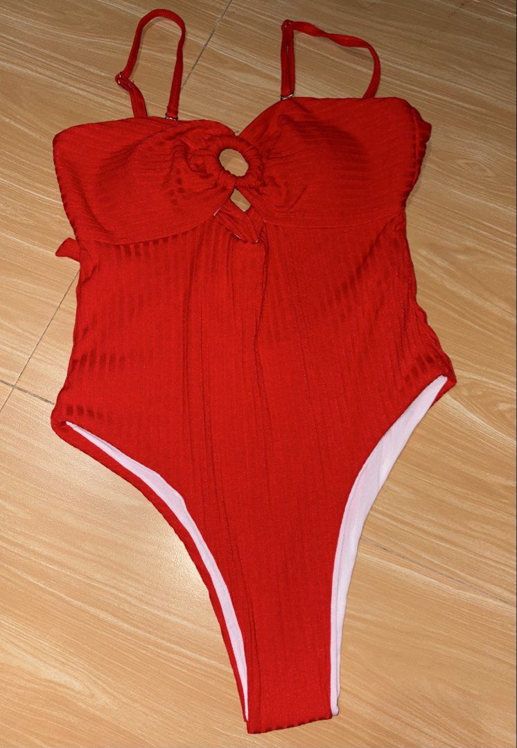 Red One-Piece Swimsuit with O-Ring Cutout (Category: Bikinis & Swimsuits) located in Caloocan City. Submitted by stella_mari27 (Listing ID 1469110136, Image 1). Description: - Color: Bright red - Material: Ribbed textured fabric (fully white lined) - Design: Center O-ring cutout front - Straps: Adjustable shoulders with criss-cross back - Fit: High-cut leg openings - Best for: Beach days and poolside chilling.