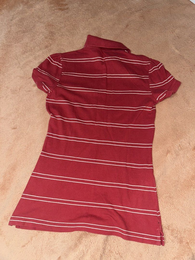 Red Striped Polo Shirt (Category: Others Tops) located in Manila. Submitted by prelovedbyanavi (Listing ID 1468954889, Image 2). Description: - Red polo shirt with horizontal white stripes - Eye-catching yellow and orange stripe across the chest - Classic collared neckline with button placket - Short sleeves and soft cotton material for a comfortable fit - Ideal for casual everyday wear.