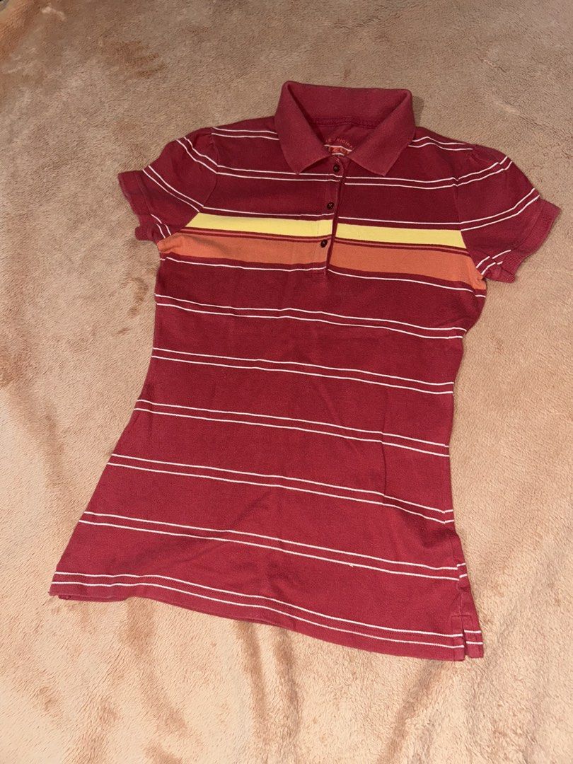 Red Striped Polo Shirt (Category: Others Tops) located in Manila. Submitted by prelovedbyanavi (Listing ID 1468954889, Image 1). Description: - Red polo shirt with horizontal white stripes - Eye-catching yellow and orange stripe across the chest - Classic collared neckline with button placket - Short sleeves and soft cotton material for a comfortable fit - Ideal for casual everyday wear.