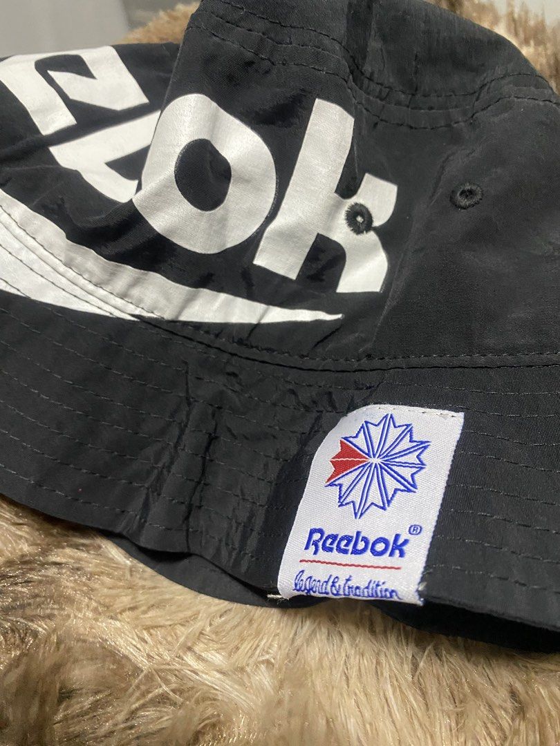 Reebok bucket hat biglogo (Category: Caps & Hats) located in Manila. Submitted by japhetcond32104 (Listing ID 1469110775, Image 2). Description: - Brand: Reebok - Item: Bucket Hat with Big Logo Design - Color: Black with white and red accents - Size: OSFX (57-60 cm) - Material: 100% Nylon (Outer), 100% Polyester (Inner lining) - Meetup location: Ayala Malls Circuit, Makati.