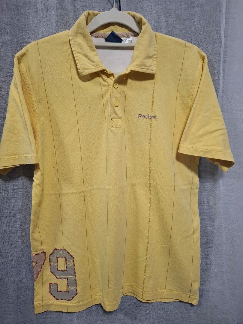 Reebok Yellow Polo Shirt Size M (Category: Tshirts & Polo Shirts ) located in Manila. Submitted by jazil.ladyliz (Listing ID 1469071822, Image 2). Description: - Brand: Reebok - Size: Medium (M) - Color: Vibrant Yellow - Material: 100% Cotton (Made in China) - Design: Classic collar, 2-button placket, stylish vertical pin stripes - Details: Embroidered Reebok logo on chest, large number 79 graphic patch near bottom hem - Condition: Excellent, rea
