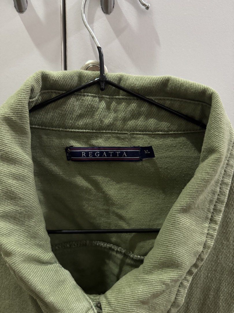 Regatta Olive Green Denim Utility Jacket Size XL (Category: Coats, Jackets and Outerwear) located in Malabon City. Submitted by marflores (Listing ID 1468939585, Image 2). Description: - Brand: Regatta - Style: Denim utility jacket - Color: Olive green - Size: XL - Material: Thick, sturdy cotton twill - Details: Collared neckline, button-up front, relaxed drop-shoulder sleeves, two buttoned chest pockets with metal brand plaque.