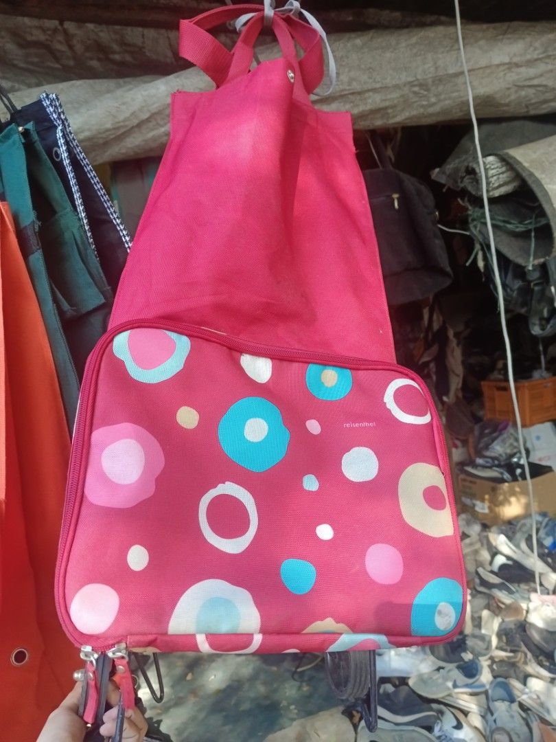 Reisenthel Red Patterned Foldable Rolling Shopping Bag (Category: Tote Bags) located in Valenzuela. Submitted by relchris22 (Listing ID 1468937797, Image 1). Description: - 30Reisenthel rolling shopping bag in a vibrant red with colorful polka dot and circle patterns - Built-in smooth-rolling wheels and bottom rails for easy and stable pulling - Foldable design for convenient storage when not in use - Sturdy top handles for comfortable carrying -