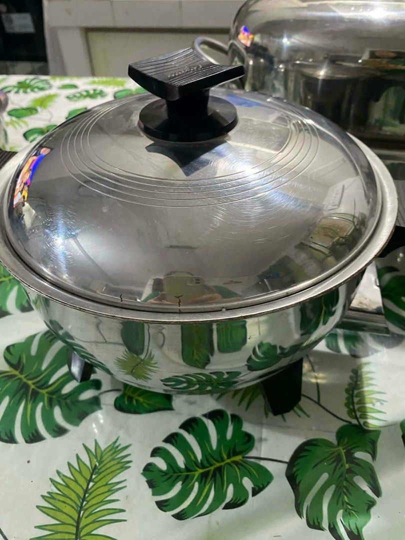 RENAWARE COOKWARE (Category: Cookers) located in Bay. Submitted by bunini7 (Listing ID 1468962131, Image 2). Description: RENAWARE VINTAGE set of vintage stainless steel waterless cookware. Material: Multi-ply or surgical-grade stainless steel. Design: Heavy-duty lids with characteristic black phenolic knobs and handles, designed for waterless or low-moisture cooking. Pieces included: The collection features various saucepans, a large roaster or 