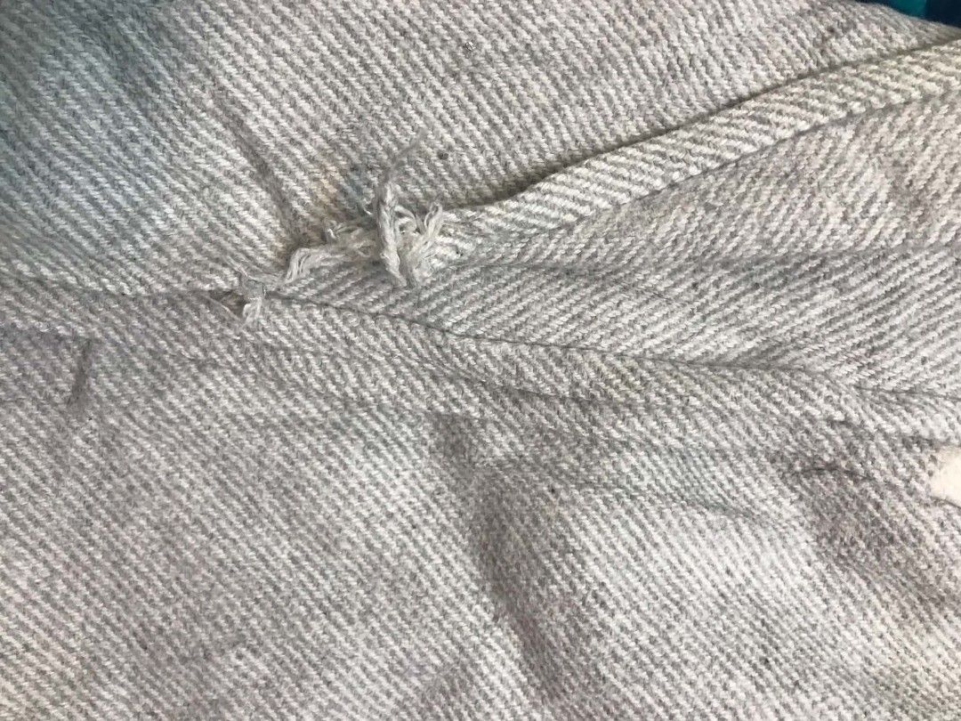 Rosa Home Grey And White Striped Throw Blanket (Category: Bedding & Towels) located in Imus. Submitted by stop_shop7 (Listing ID 1468958845, Image 2). Description: - Brand: Rosa Home - Design: Grey and white stripes with a woven herringbone texture and fringe ends - Material: Soft and comfortable fabric - Use: Perfect for draping over a sofa, couch, or bed - Condition: Good, with minor fraying on one section of the weave near the edge.