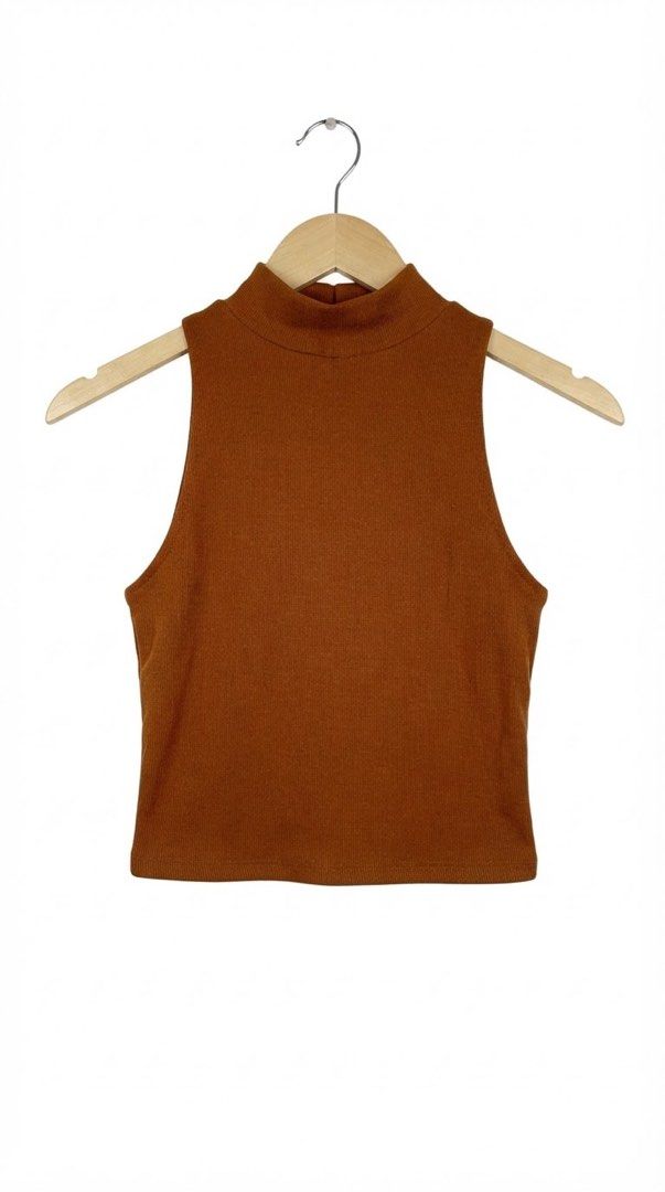 Rust brown sleeveless ribbed mock neck crop top (Category: Sleeveless) located in Cavite. Submitted by grandearth.39df3f (Listing ID 1468954965, Image 1). Description: - Color: Rust brown - Style: Sleeveless ribbed crop top with a high mock neck - Material: Soft, stretchy knit - Condition: Well-kept and clean - Versatility: Great basic piece for layering or pairing with high-waisted jeans.