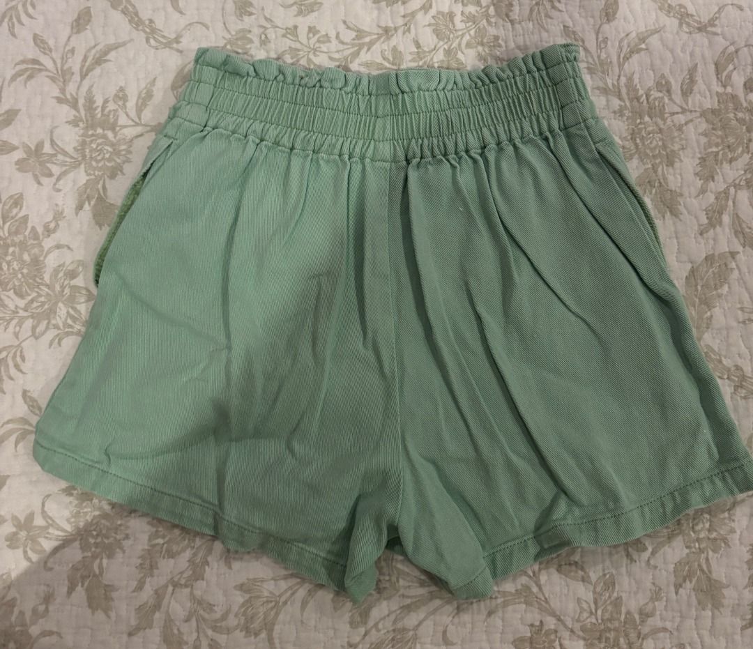 Sage Green High-Waisted Wrap Skort (Category: Skirts) located in Muntinlupa City. Submitted by wisemountain-8175 (Listing ID 1469039766, Image 2). Description: - Singaporean Brand - Size: M (EUR 38, UK 10) - Color: Sage green (perfect for summer) - Material: Lightweight cotton-blend fabric - Design: High waist, gathered elasticated band, and decorative front buttons - RFS: too small.