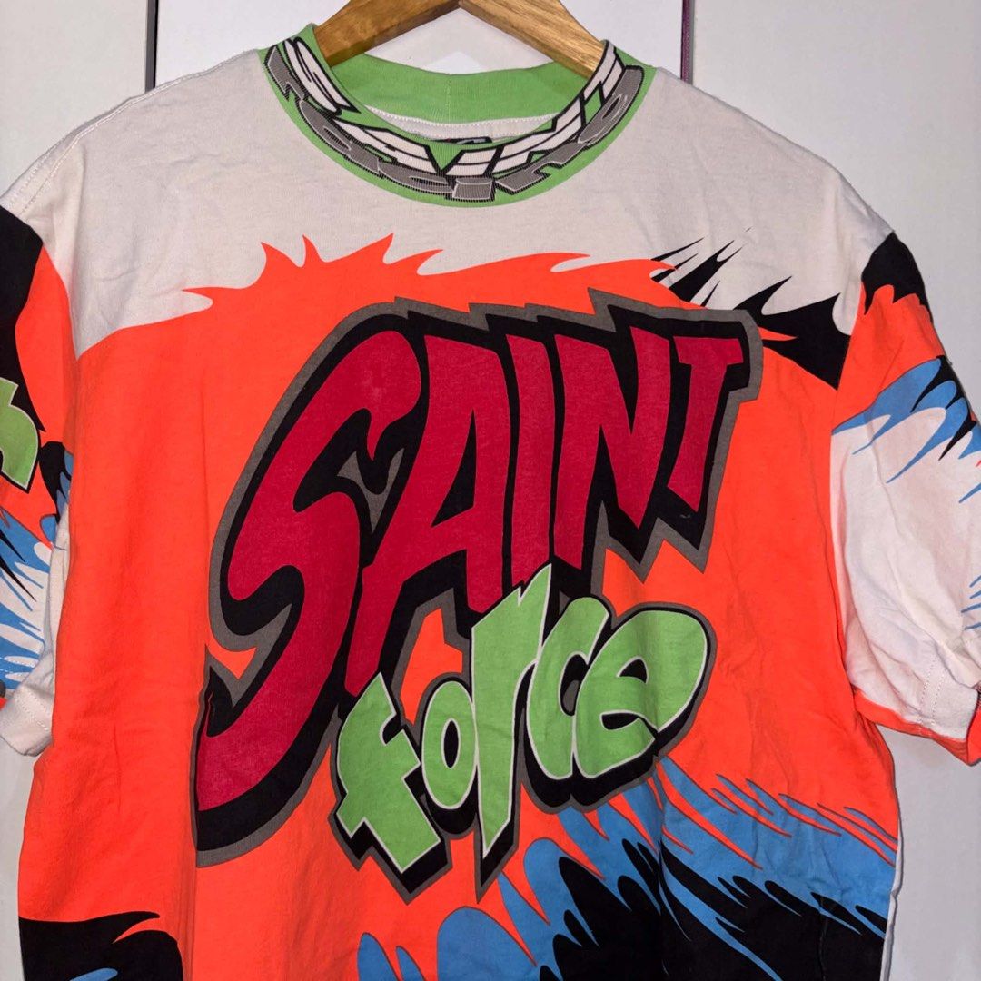 Saint Michael Graphic Tee (Category: Tshirts & Polo Shirts ) located in Rosario. Submitted by elyukano2506 (Listing ID 1469020709, Image 3). Description: - Brand: Saint Michael -size Large - Color: White with multi-color graffiti print - Material: Heavyweight 100% cotton - Details: Green ribbed collar with chain print, colorful block panels - Size: Small (tag in photos) - Origin: Made in Japan - Condition: Excellent.