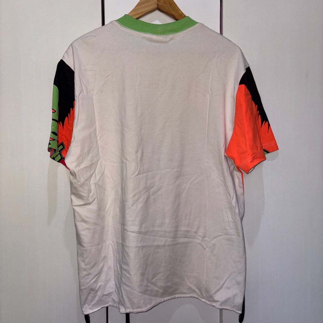 Saint Michael Graphic Tee (Category: Tshirts & Polo Shirts ) located in Rosario. Submitted by elyukano2506 (Listing ID 1469020709, Image 2). Description: - Brand: Saint Michael -size Large - Color: White with multi-color graffiti print - Material: Heavyweight 100% cotton - Details: Green ribbed collar with chain print, colorful block panels - Size: Small (tag in photos) - Origin: Made in Japan - Condition: Excellent.
