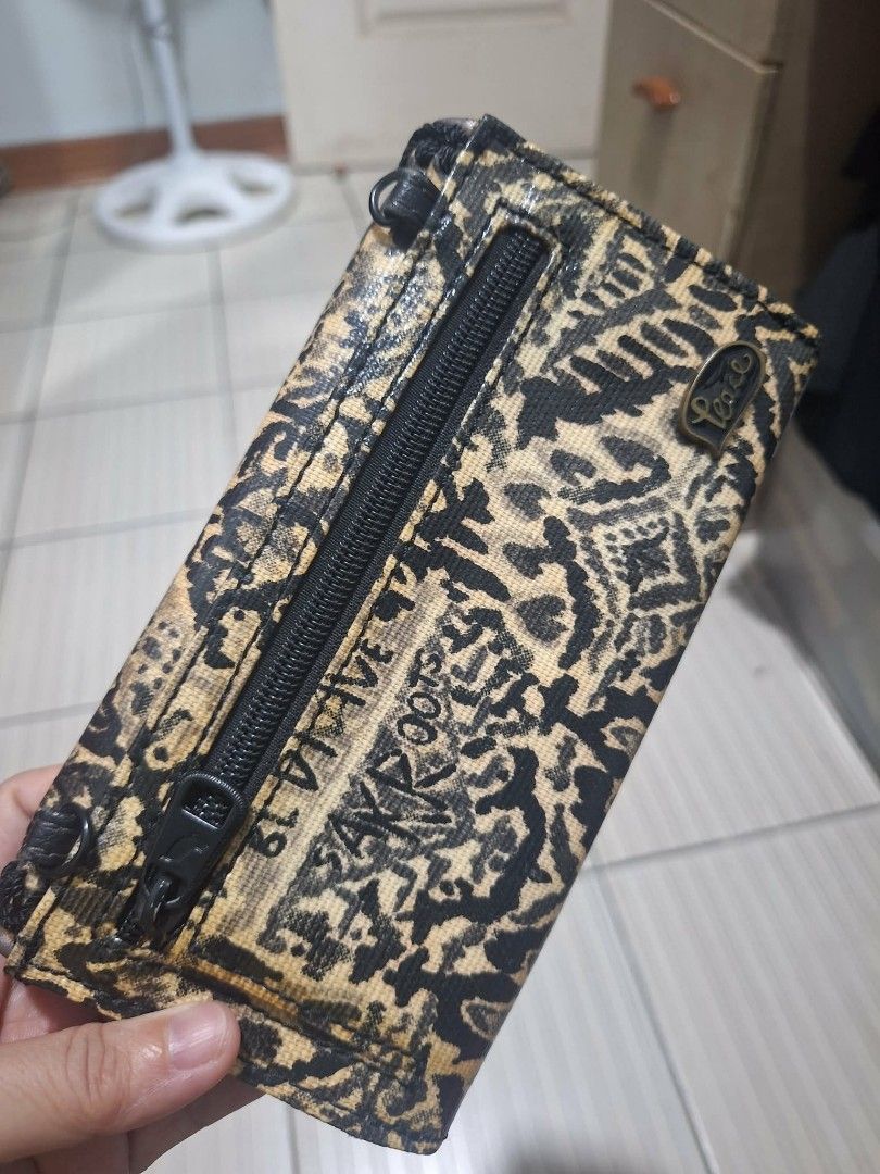 Sakroots Black and Gold Pattern Wallet (Category: Wallets & Card holders) located in Dasmarinas. Submitted by jazvielle (Listing ID 1469088197, Image 3). Description: - Brand: Sakroots - Design: Black and yellow patterned fabric with chic black whipstitch trim - Exterior: Convenient zip pockets on the outside and back - Interior: Multiple card slots, clear ID window, and spacious compartments for cash or a smartphone - Condition: Clean interior, 