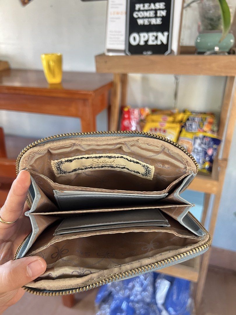 Salad Light Blue Leather Zip Wallet (Category: Wallets & Card holders) located in Baguio. Submitted by chiechie1234 (Listing ID 1469158323, Image 3). Description: - Brand: Salad - Material: Light blue leather with gold-tone hardware - Closure: Secure zip-around closure - Interior: Multiple card slots and stylish printed fabric lining - Size: Compact and easy to fit into any bag - Condition: Normal signs of use on the leather surface.
